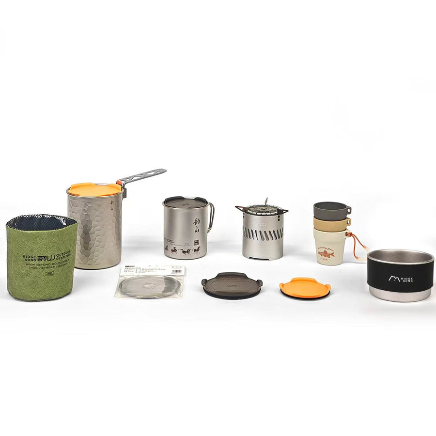 A modular cookware set with a pot, mugs, shallow bowl, stove, small cups and lids on a light background.