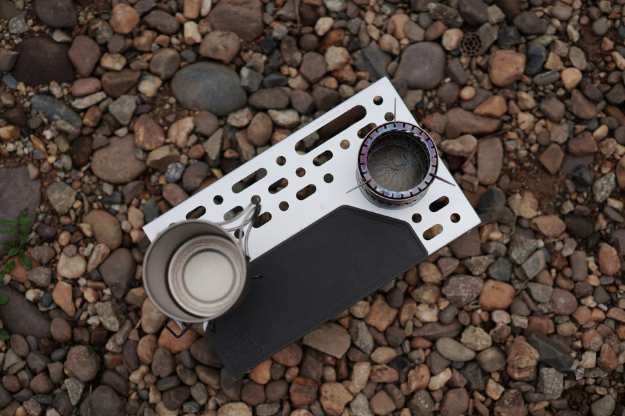 The perforated Wild Cook trekking table viewed from above on a rocky surface.