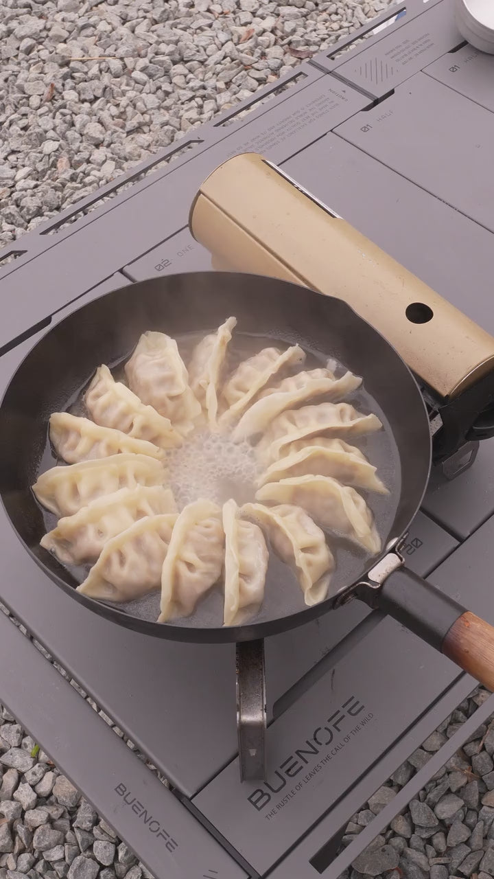 Load video: Dumplings cooking in the YS012 pan at camp; no audio