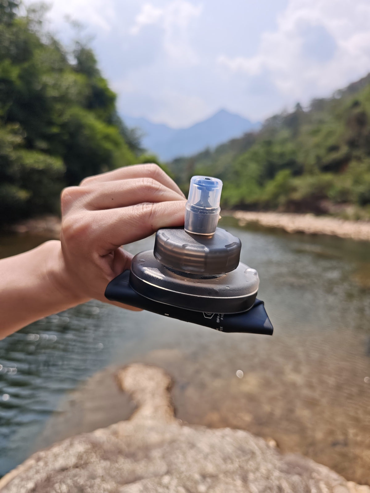 Empty soft flask folded down in one hand