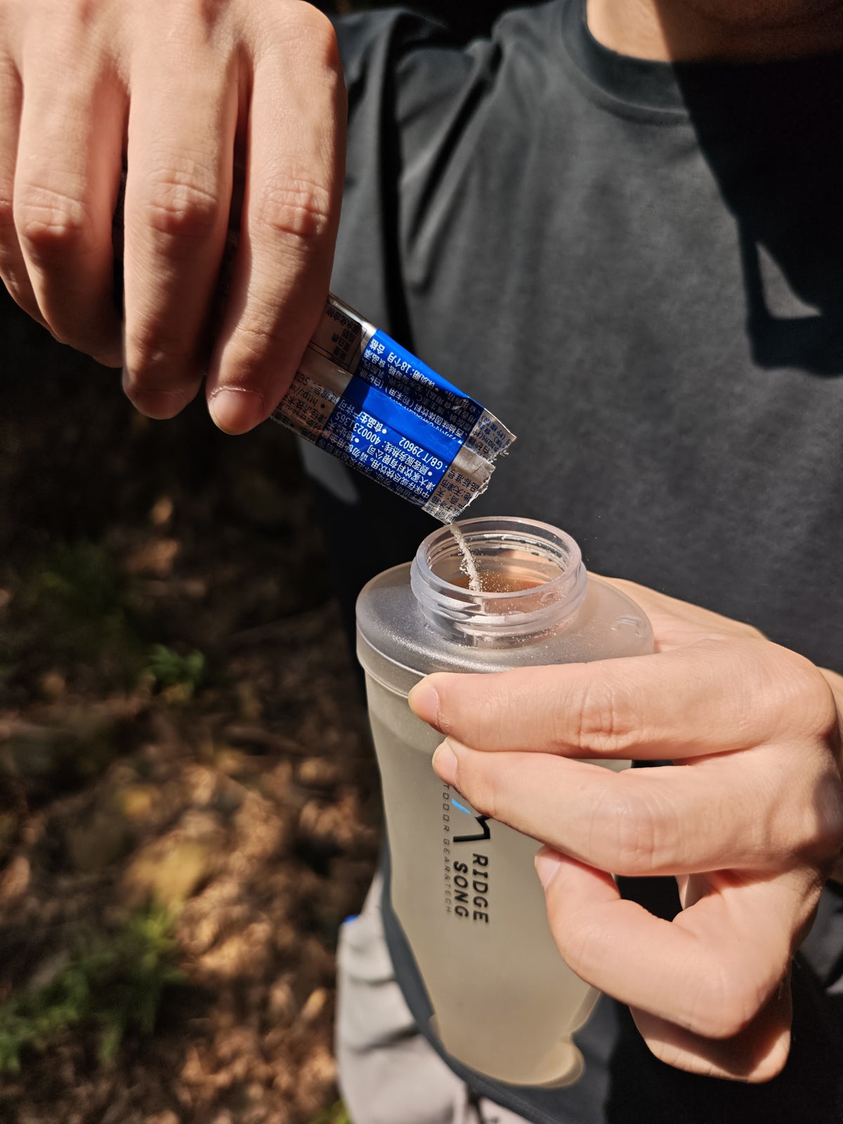 Adding drink mix through the wide flask opening