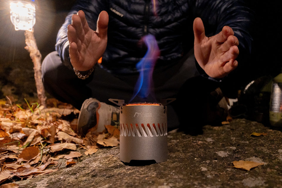 Blaze Turbo Alcohol Stove heating RidgeSong hammered cookware at a forest camp