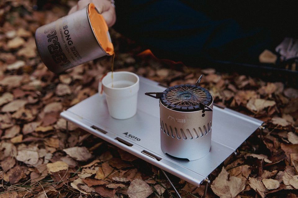 Water being poured at a compact Blaze stove trail setup