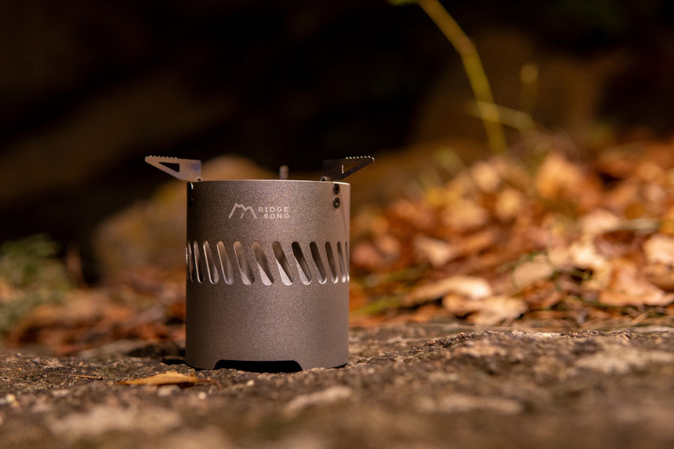 Blaze stove operating outdoors with the integrated wind shield surrounding the flame