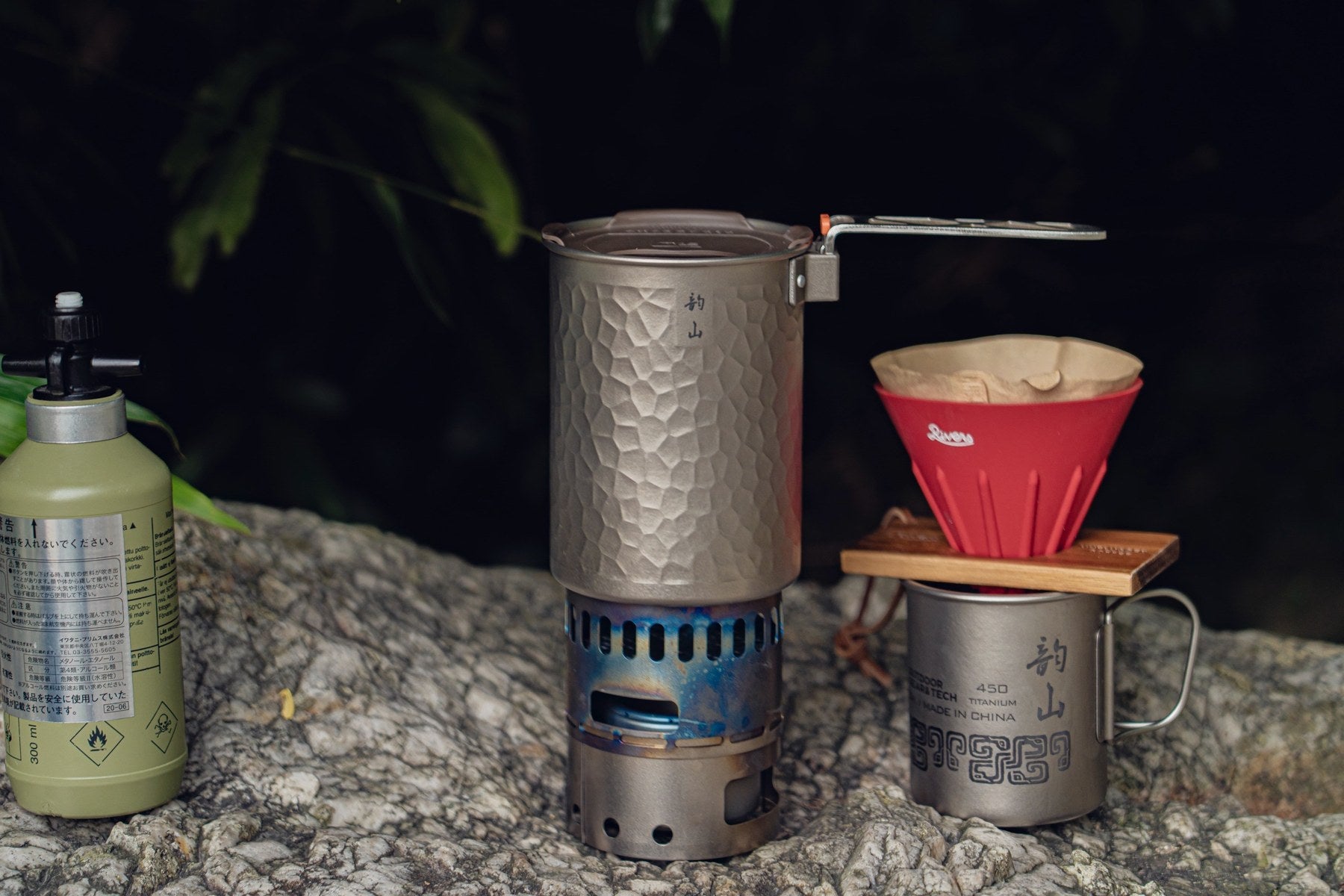 The pot and alcohol stove beside a titanium mug with a separate coffee dripper