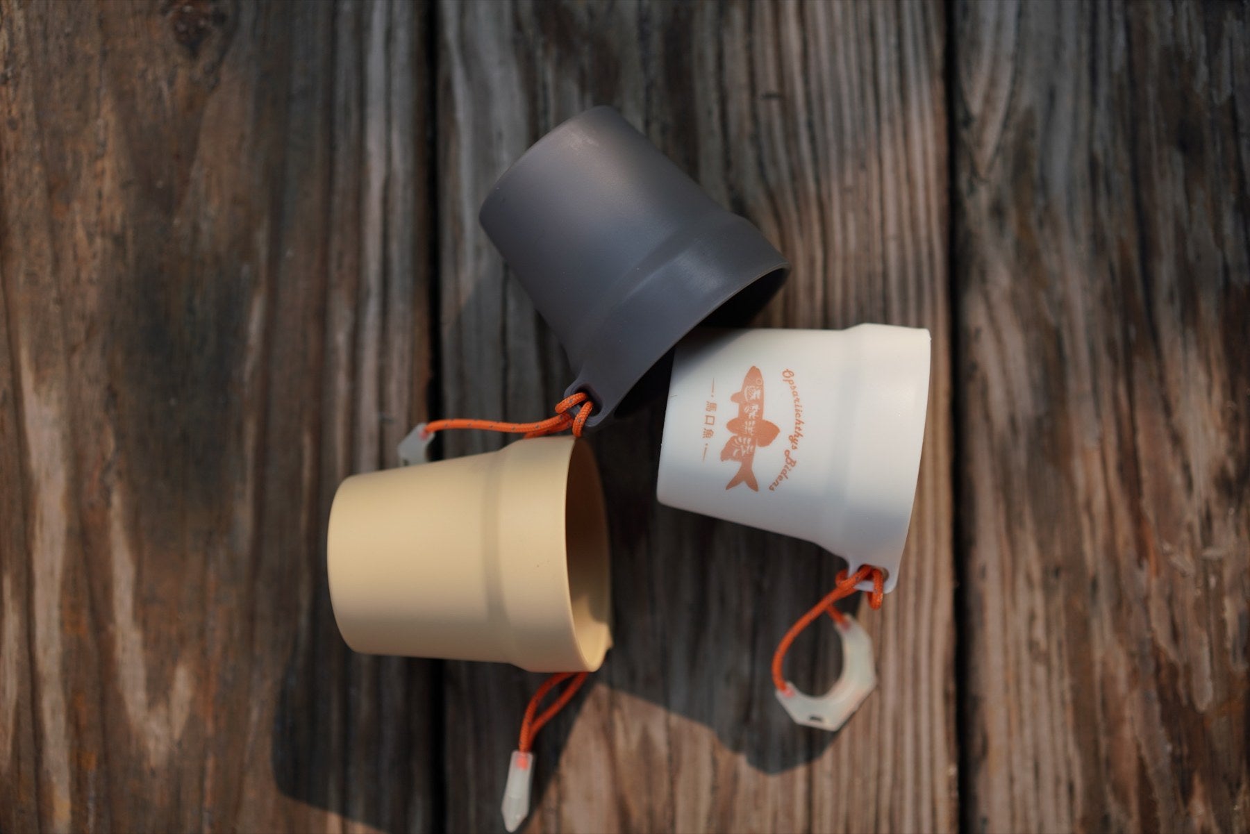 Three sharing cups arranged on a wooden table